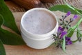 A jar of homemade comfrey root ointment with comfrey flowers and Royalty Free Stock Photo