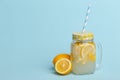 A jar of homemade lemonade and lemons on a blue background Royalty Free Stock Photo