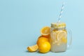 A jar of homemade lemonade and lemons on a blue background Royalty Free Stock Photo