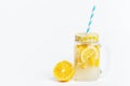 A jar of homemade lemonade and lemons on a white background Royalty Free Stock Photo