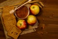 Jar of honey, apples, rye bread, ears on sacking, wooden table Royalty Free Stock Photo