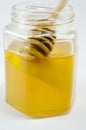 Jar of honey with a dipper Royalty Free Stock Photo