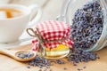 Jar of honey, dry healthy lavender tea and tea cup