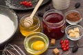 Jar of honey and jam. Broken egg in cup. Flour and berries. Ingredients for baking berry pie Royalty Free Stock Photo