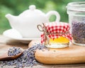 Jar of honey, lavender tea and teapot on background.