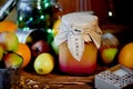 A jar of honey in the middle of citrus, lit garland.The warm atmosphere of the holidays. And vitamins during illness Royalty Free Stock Photo