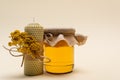 Jar with honey near handmade candle