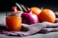 Jar of honey with oranges and pomegranate on woven fabric with dark background Royalty Free Stock Photo