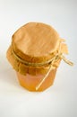 Jar of honey with a paper cover tied with a rope