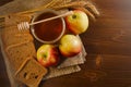 Jar of honey, pieces of rye bread, ripe apples and wheat ears on sacking. Royalty Free Stock Photo