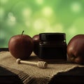 Jar with honey and red apples on a cloth surface on a wooden table. Green background Royalty Free Stock Photo