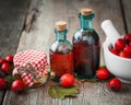 Jar of honey, tincture bottles and mortar of hawthorn berries Royalty Free Stock Photo