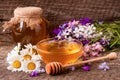Jar of honey with wildflowers and chamomile on old wooden background Royalty Free Stock Photo