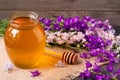 Jar of honey with wildflowers on a dark wooden background Royalty Free Stock Photo