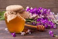 Jar of honey with wildflowers on a dark wooden background Royalty Free Stock Photo