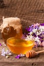 Jar of honey with wildflowers on old wooden background Royalty Free Stock Photo