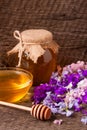 Jar of honey with wildflowers on old wooden background Royalty Free Stock Photo