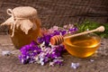 Jar of honey with wildflowers on old wooden background Royalty Free Stock Photo