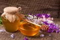 Jar of honey with wildflowers on old wooden background Royalty Free Stock Photo