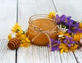 Jar of honey with wildflowers Royalty Free Stock Photo