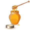 Jar of honey with wooden dipper