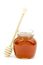 Jar of honey and wooden dripper Royalty Free Stock Photo