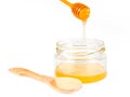 Jar of honey with wooden drizzler Royalty Free Stock Photo