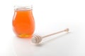 Jar of honey with wooden drizzler