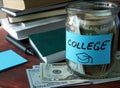 Jar with label college and money on the table.