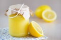A jar of lemon curd with a lemon Royalty Free Stock Photo