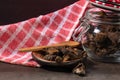 Jar with mushrooms, a dish towel and dried pine mushrooms in a small plate on a table Royalty Free Stock Photo