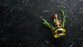 Jar of olive oil with spices on a dark background. Top view. Free space for your text
