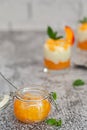 Jar of peach jam on white brick wall background Royalty Free Stock Photo