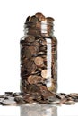 Jar of pennies overflowing Royalty Free Stock Photo