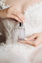 Jar of perfume in the hands of the bride. Beautiful wedding manicure.Hands closeup. Wedding morning bride Royalty Free Stock Photo