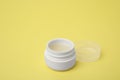 Jar of petroleum jelly on yellow background Royalty Free Stock Photo