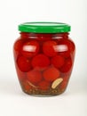 Jar of pickled small red cherry tomatoes on white Royalty Free Stock Photo