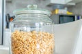 Jar of plain granola, made from toasted oats, as museli, on kitchen table in daylight, for breakfast food Royalty Free Stock Photo