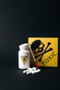 Jar with poison signs by pills and syringe Royalty Free Stock Photo