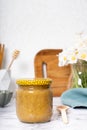 Jar with propolis honey on kitchen table still life