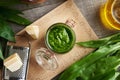 A jar of ramson or bear\'s garlic pesto on a table, top view Royalty Free Stock Photo