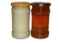 A jar of rapeseed honey and a jar of polyfloral honey Royalty Free Stock Photo