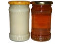 A jar of rapeseed honey and a jar of polyfloral honey Royalty Free Stock Photo