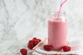 Jar with rasberry smoothie and fresh rasberry on tawel on white background Royalty Free Stock Photo