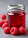 A jar of raspberry jam with raspberries on a table Royalty Free Stock Photo