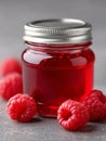 A jar of raspberry jam with raspberries on a table Royalty Free Stock Photo