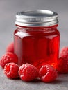 A jar of raspberry jam with raspberries on a table Royalty Free Stock Photo