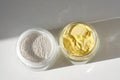 A jar of rice flour face scrub and a jar of turmeric face scrub. Royalty Free Stock Photo