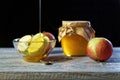 Jar of rustic honey and and apples on wooden table. Traditional celebration food for the Jewish New Year. Concept Rosh Hashana Royalty Free Stock Photo