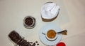 Jar with spilled coffee beans on linen tablecloth with cup of espresso full with spoon. Royalty Free Stock Photo